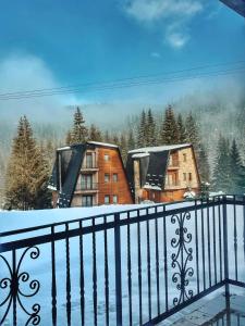 a view from a balcony with snow on the ground at Planinska kuća Dunja in Jahorina
