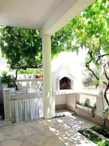 a patio with an outdoor oven in a yard at Apartment Anita in Trogir