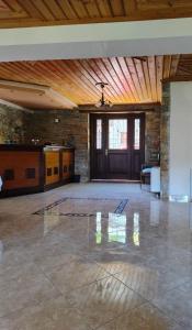 an empty room with a stone wall and a wooden ceiling at Evridiki in Zagora