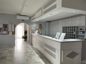 a kitchen with a white counter and a hallway at Albatros Hotel in Karterados