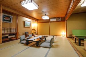 a living room with a table and a pool table at Yanagiso in Toyooka