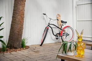 a bike parked next to a bench with a statue of a rabbit at Vibes At Five Noosa in Noosaville