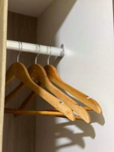 a group of wooden hangers on a rack at Arkisha’s Cozy Place in Manila