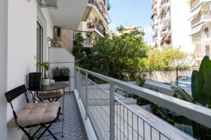 a balcony with two chairs and a table on it at Adela's 1 BR & Living room in Athens