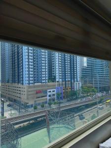 a view from a window of a city with buildings at Arkisha’s Cozy Place in Manila
