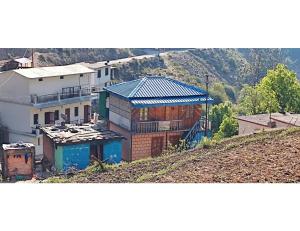 a group of buildings sitting on top of a hill at Sandeep Home stay, Chakrata in Chakrāta