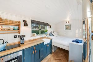 a kitchen with a bed and a sink in a room at Oak + Stars Hideaway in Holmfirth