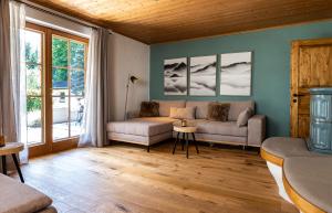 a living room with a couch and a table at Chalet im Rad - Wanderparadis Tiroler Zugspitze Arena in Ehrwald