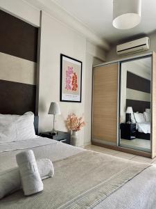 a bedroom with a large bed with a large mirror at Mc Queen Rooms & Apartments in Athens
