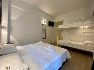 a bedroom with two beds and a bunk bed at Platon Hotel in Piraeus