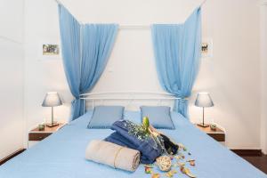 a bedroom with a blue bed with blue curtains at Alegria rooms in Athens