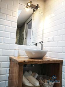 a bathroom with a sink and a mirror at Cabanela Maitia Apto Telmo Duplex in Ribadeo