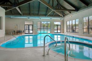 a large swimming pool with blue water in a building at Cypress Bend Resort, a Wyndham Hotel in Many