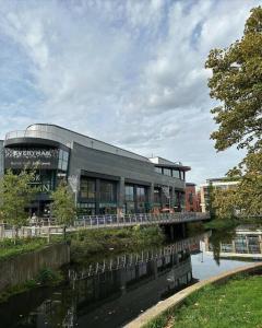 a building with a bridge over a river at Bond Street Luxury Apartment Central Chelmsford in Chelmsford