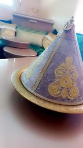 a purple and gold bowl on a table at Bel appartement ,uniquement pour les familles in Meknès