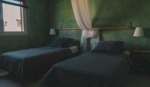 Cama o camas de una habitación en Hostal Esfigueral