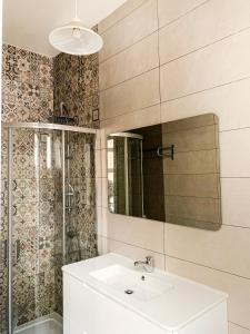 a bathroom with a sink and a mirror at L'Artist Casa Micallef in Valletta