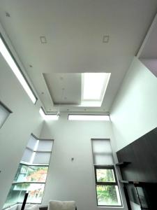 a living room with a skylight and two windows at Teluk Cempedak Seventh Haven in Kuantan