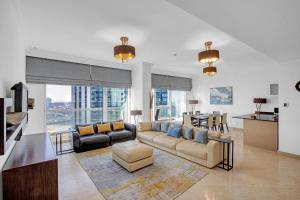 a living room with a couch and a table at VayK - Modern Four Bedroom with Sea View in Dubai Marina in Dubai