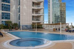 a swimming pool in front of some tall buildings at VayK - Modern Four Bedroom with Sea View in Dubai Marina in Dubai