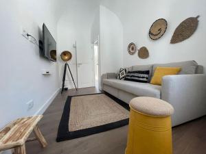 a living room with a couch and a table at Casa da Oliveira in Évora