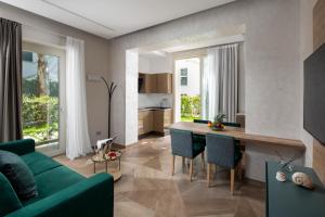 a living room with a green couch and a table at Elegance Riccione in Riccione