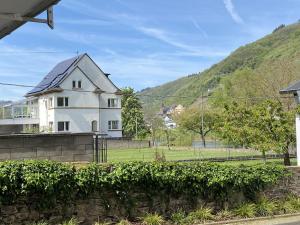 a white house with a hill in the background at MOSELTEL Ernst,Cochem in Ernst +35 photos