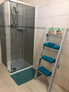 a bathroom with a shower with blue towels at B&B Isola Mia in La Maddalena