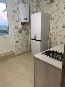a kitchen with a white refrigerator and a stove at Одесса ЖК 7 Небо Аквапарк Рынок-7 Проездная,28 in Odesa