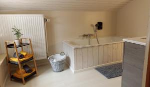 a bathroom with a tub and a sink at Gite : Le vi colombage de Petites-Tailles in Vielsalm