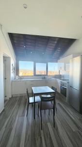 a kitchen with a table and chairs in a room at LAS MESAS HOUSE Ocean Escape in San Miguel de Abona