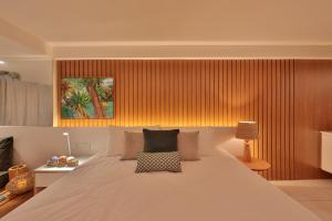 a bedroom with a large bed with a white bedspread at HY Apartments & Hotels in Recife