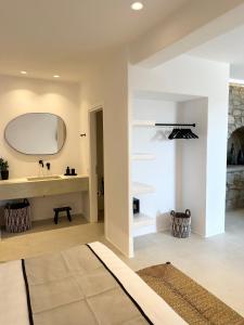 a bathroom with a sink and a mirror at Quattro Venti Suites Mykonos in Tourlos