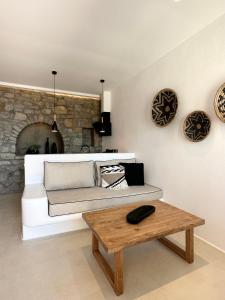 a living room with a couch and a table at Quattro Venti Suites Mykonos in Tourlos