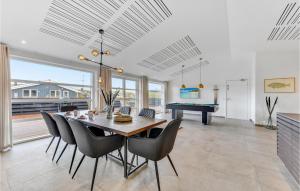 a dining room with a table and a pool table at Amazing Home In Hvide Sande With Outdoor Swimming Pool in Hvide Sande