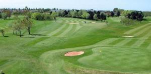 an aerial view of a green golf course at Redstone Rise Luxury house sleeps 7 in Birkenhead