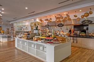 a bakery with a counter with food on it at Royal Lotus Hotel Danang in Danang