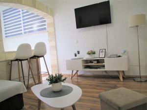 a living room with a flat screen tv on the wall at Family Apartment Romina in Vrsar