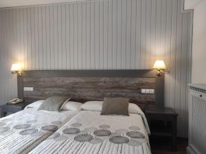 a bedroom with a large bed with two night stands at Snö Hotel Bielsa in Bielsa