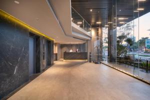 an empty lobby of a building with a bar at San Marino Boutique Danang - 10 mins to Dragon Bridge & 15 mins to My Khe Beach in Da Nang +76 photos