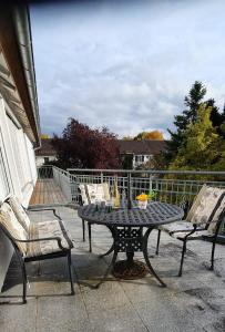 un patio con mesa y sillas en un porche en Ferienwohnung Ott Schongau en Schongau