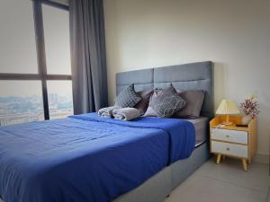 a bedroom with a blue bed with a window at 3 bedrooms maxim link MRT cheras kuala lumpur in Kuala Lumpur +40 photos