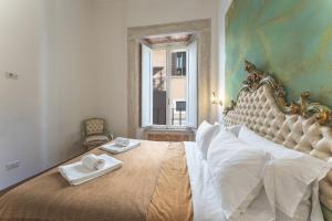 a bedroom with a large bed with two towels on it at Palazzo Pamphili Lecca di Guevara in Rome
