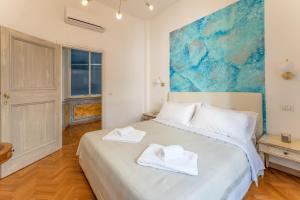 a bedroom with a bed with towels on it at Palazzo Pamphili Lecca di Guevara in Rome