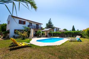 a yard with a pool and two chairs and a house at Villa Pomos Med. in Pomos