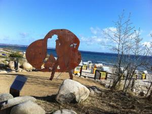 a large metal sculpture of a bird on a beach at Moderne Kurparkresidenz in Timmendorfer Strand