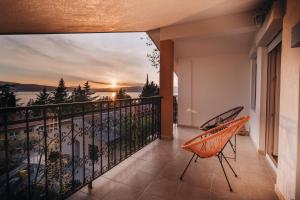 a balcony with a view of a sunset at Villa Pandora in Ohrid