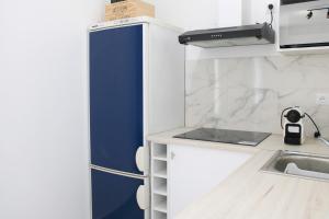 eine Küche mit einem blauen Kühlschrank und einer Spüle in der Unterkunft Newly renovated cocoon with terrace near the Seine in Ivry-sur-Seine