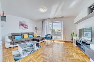 a living room with a couch and a table at Apartments Birimac in Pula