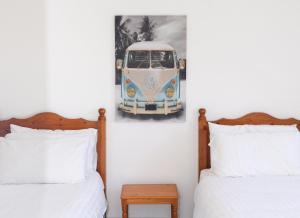 a bedroom with two beds and a picture of a van on the wall at Ballybunion Holiday Cottage No 10 in Ballybunion